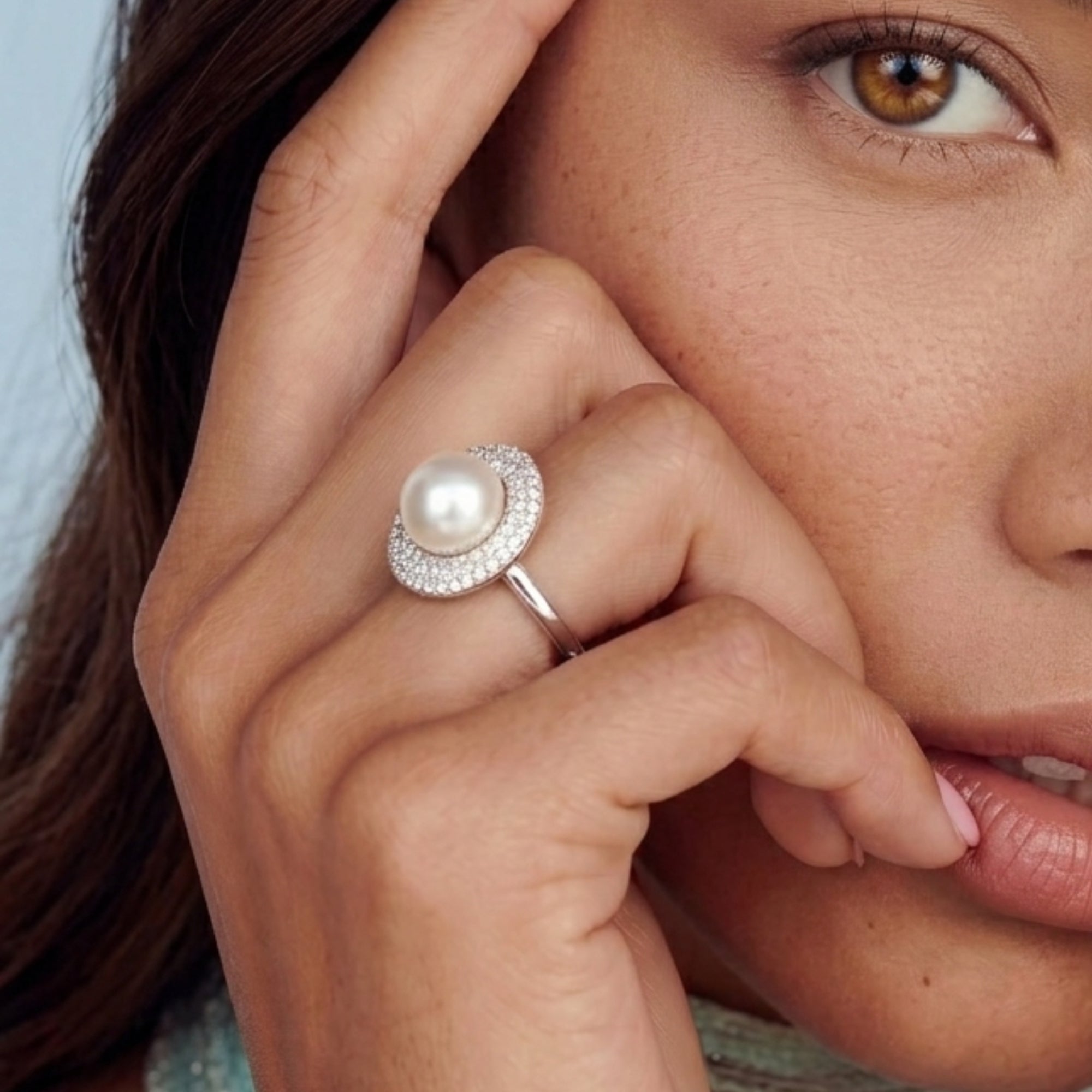 Woman wearing pearl and pave crescent ring in sterling silver, freshwater pearl with silver halo | VAHN Jewels