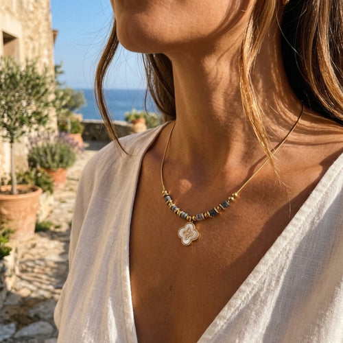  Woman wearing abalone clover charm necklace in 18K gold plated stainless steel by VAHN Jewels