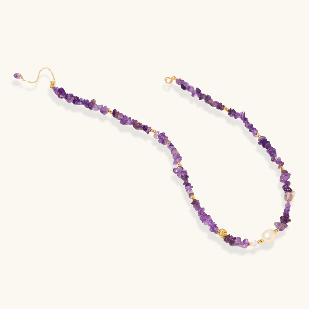 Close-up of gold vermeil medallion and freshwater pearl drop on amethyst beaded necklace by VAHN Jewels