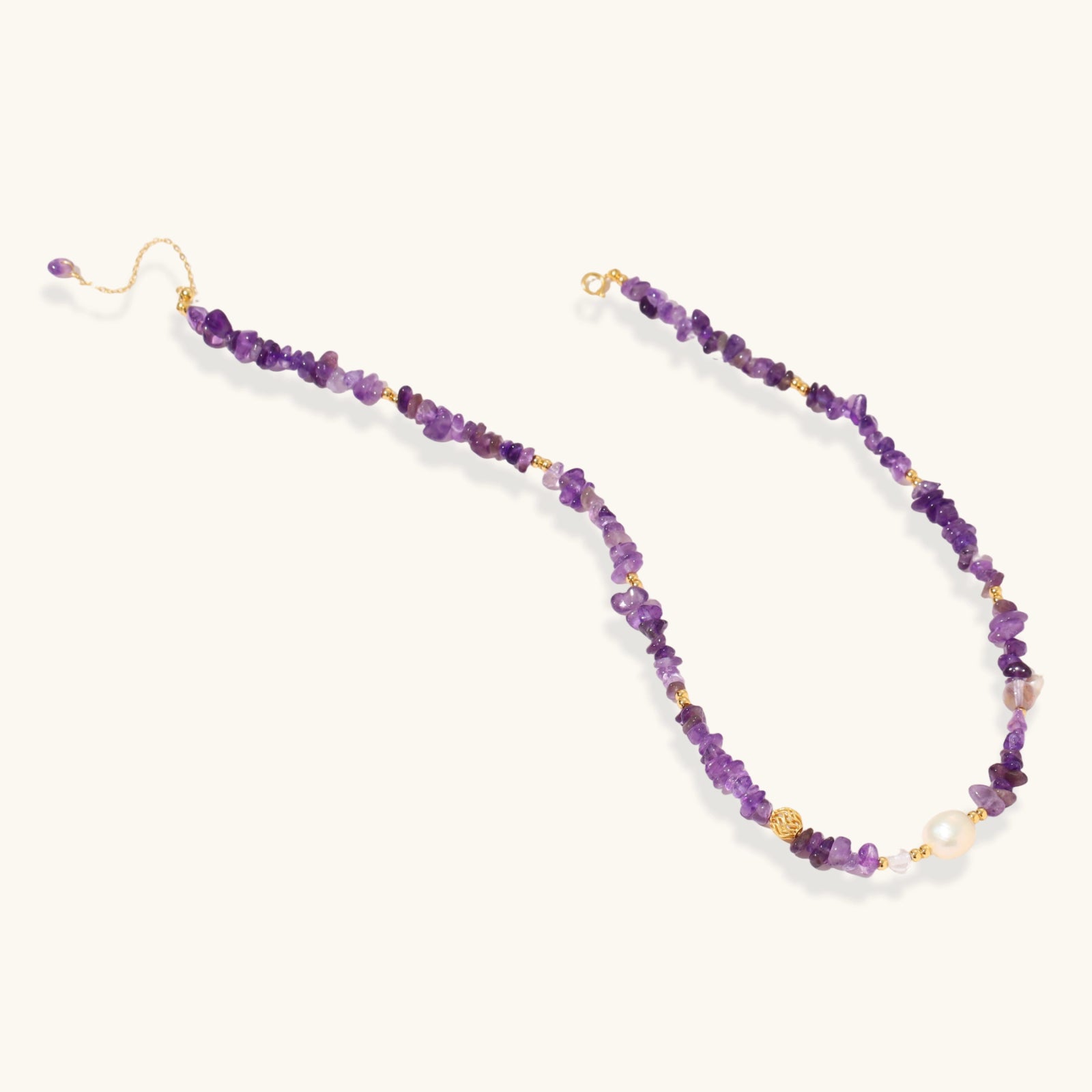 Close-up of gold vermeil medallion and freshwater pearl drop on amethyst beaded necklace by VAHN Jewels