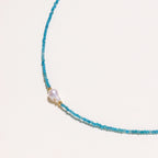 Detail view of faceted teal apatite beads and gold vermeil accents on apatite pearl beaded necklace by VAHN Jewels