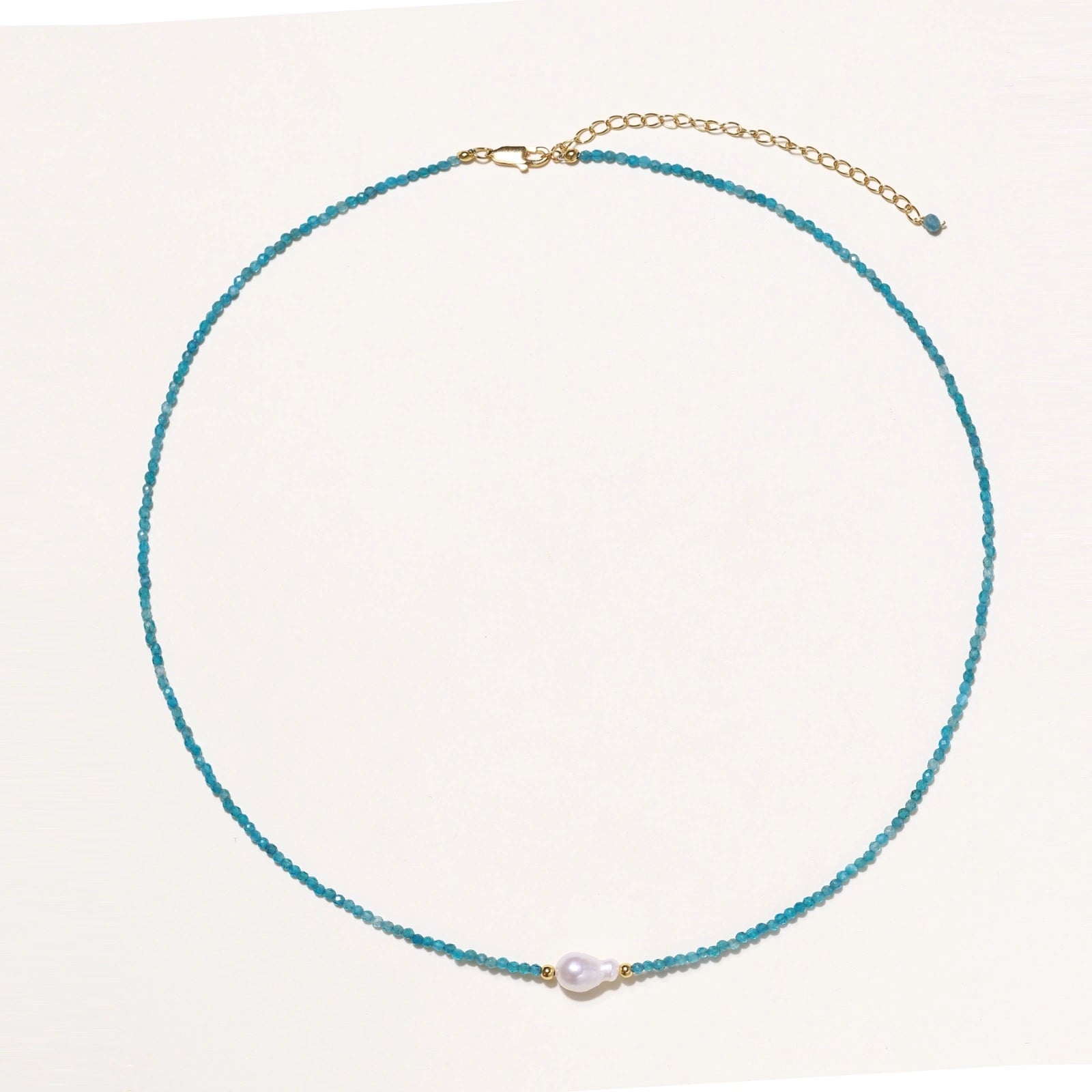 Flat lay of apatite pearl beaded vermeil necklace in 18K gold vermeil with turquoise apatite beads