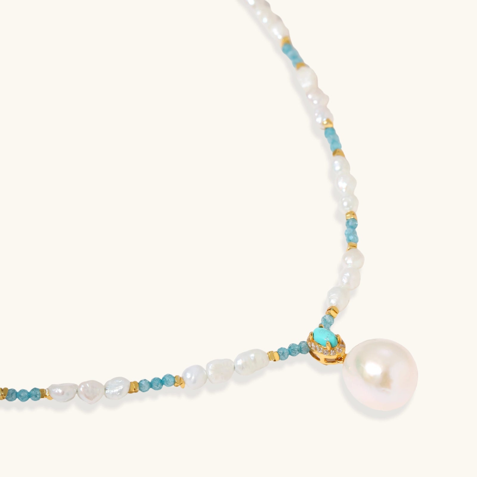 Close-up of turquoise cabochon pendant with pave zircon halo and Edison pearl drop in 925 sterling silver