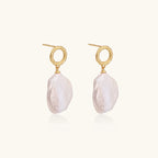 Side angle view of baroque pearl drop earrings showing twisted gold vermeil loop and pearl movement by VAHN Jewels