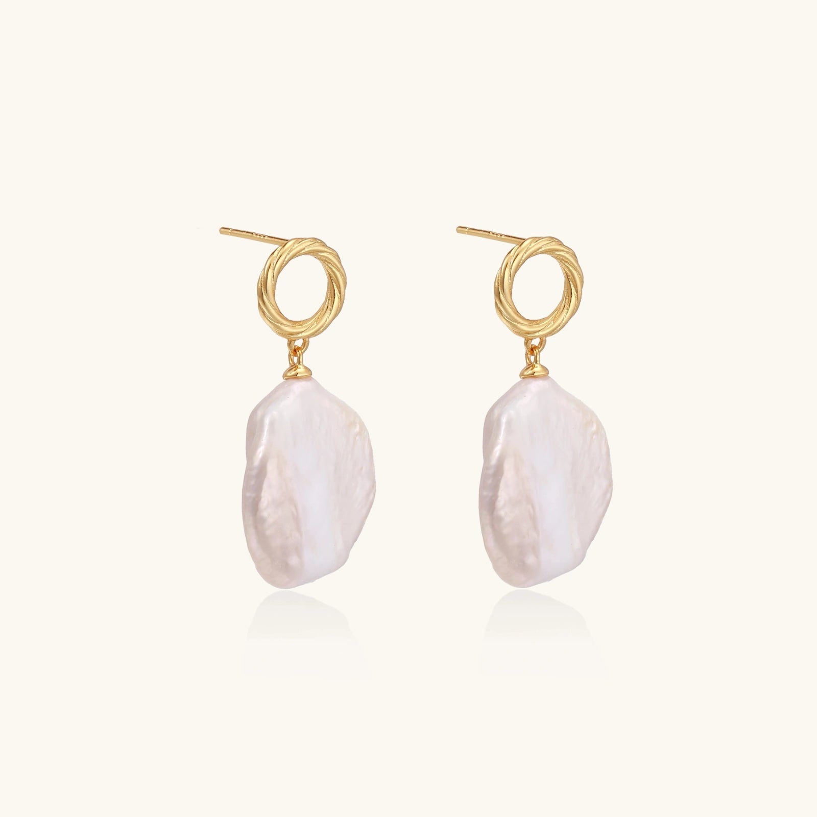 Side angle view of baroque pearl drop earrings showing twisted gold vermeil loop and pearl movement by VAHN Jewels