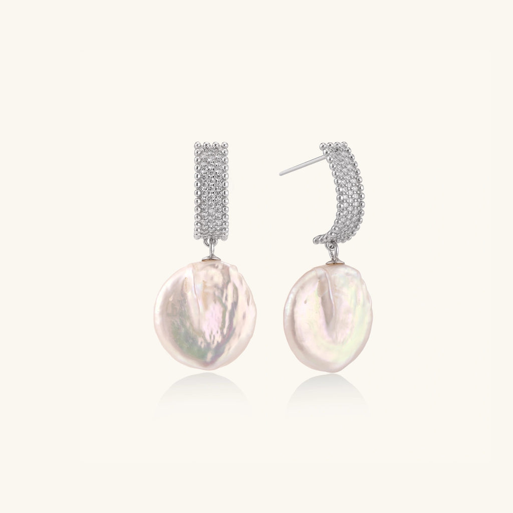 Close-up of baroque pearl drops with pave crystal in rhodium-plated silver