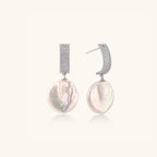 Close-up of baroque pearl drops with pave crystal in rhodium-plated silver