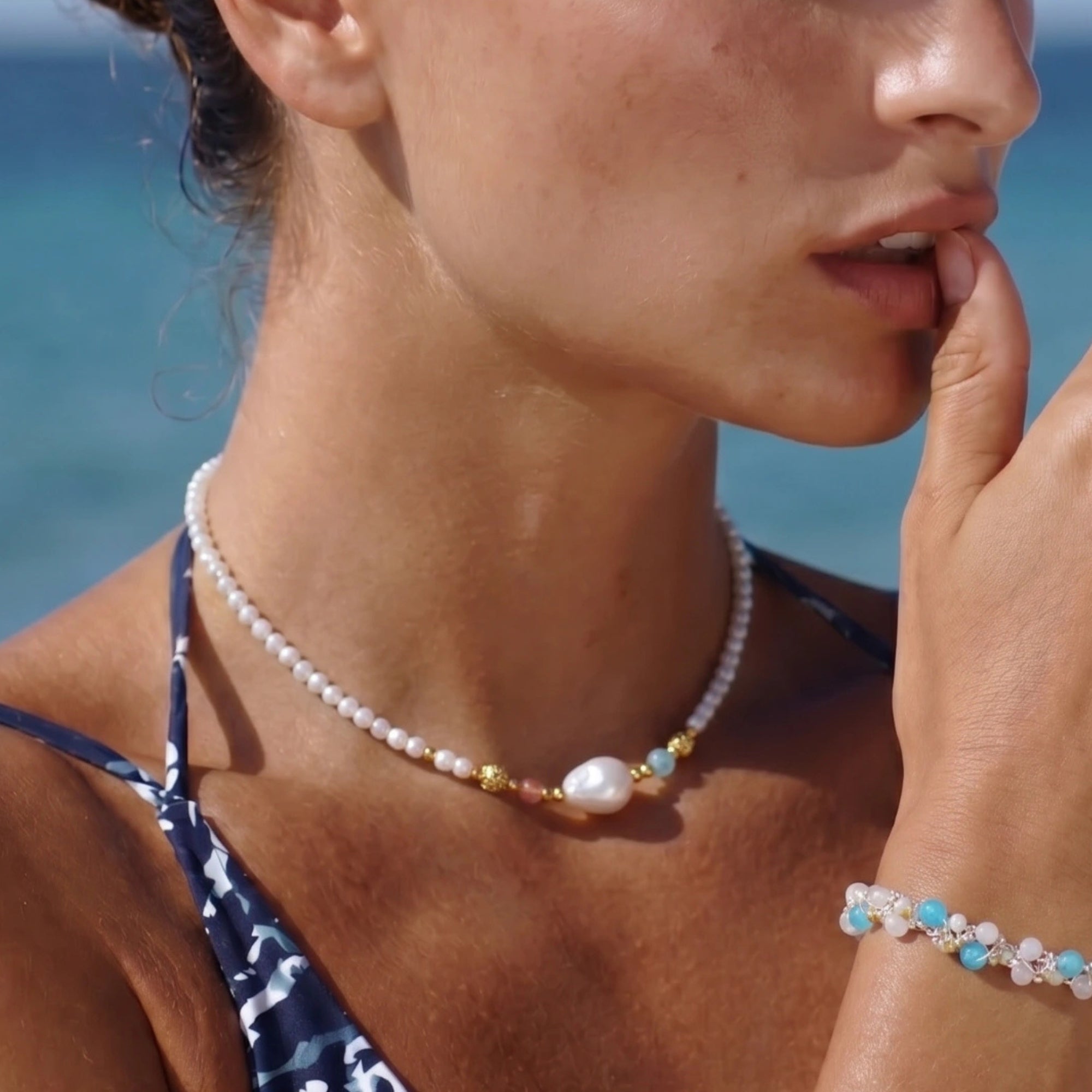 Woman wearing baroque pearl garden necklace outdoors by the ocean by VAHN Jewels