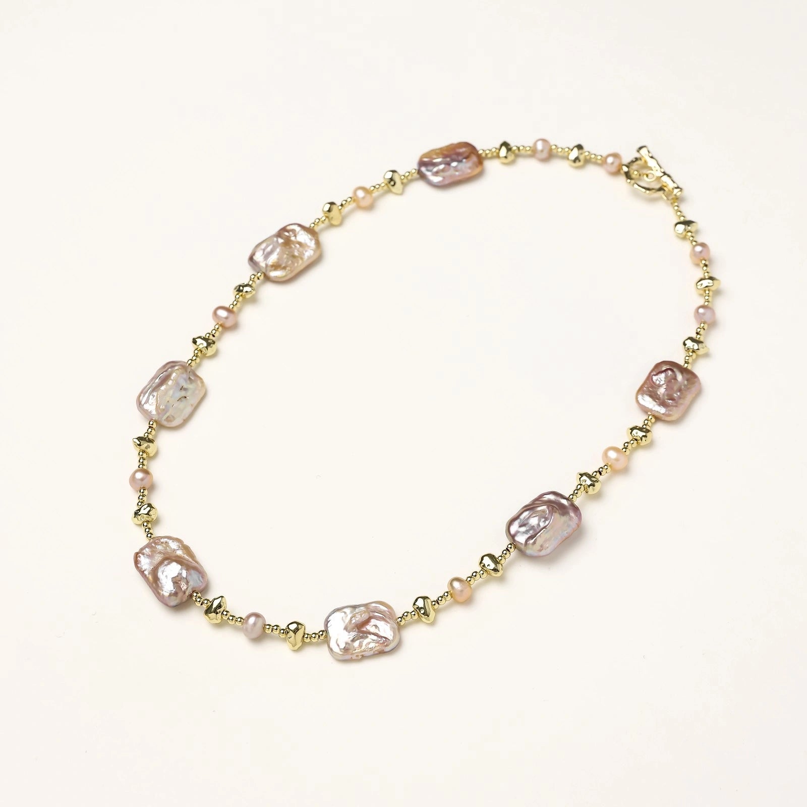 Baroque pearl necklace laid flat with iridescent freshwater pearls VAHN Jewels