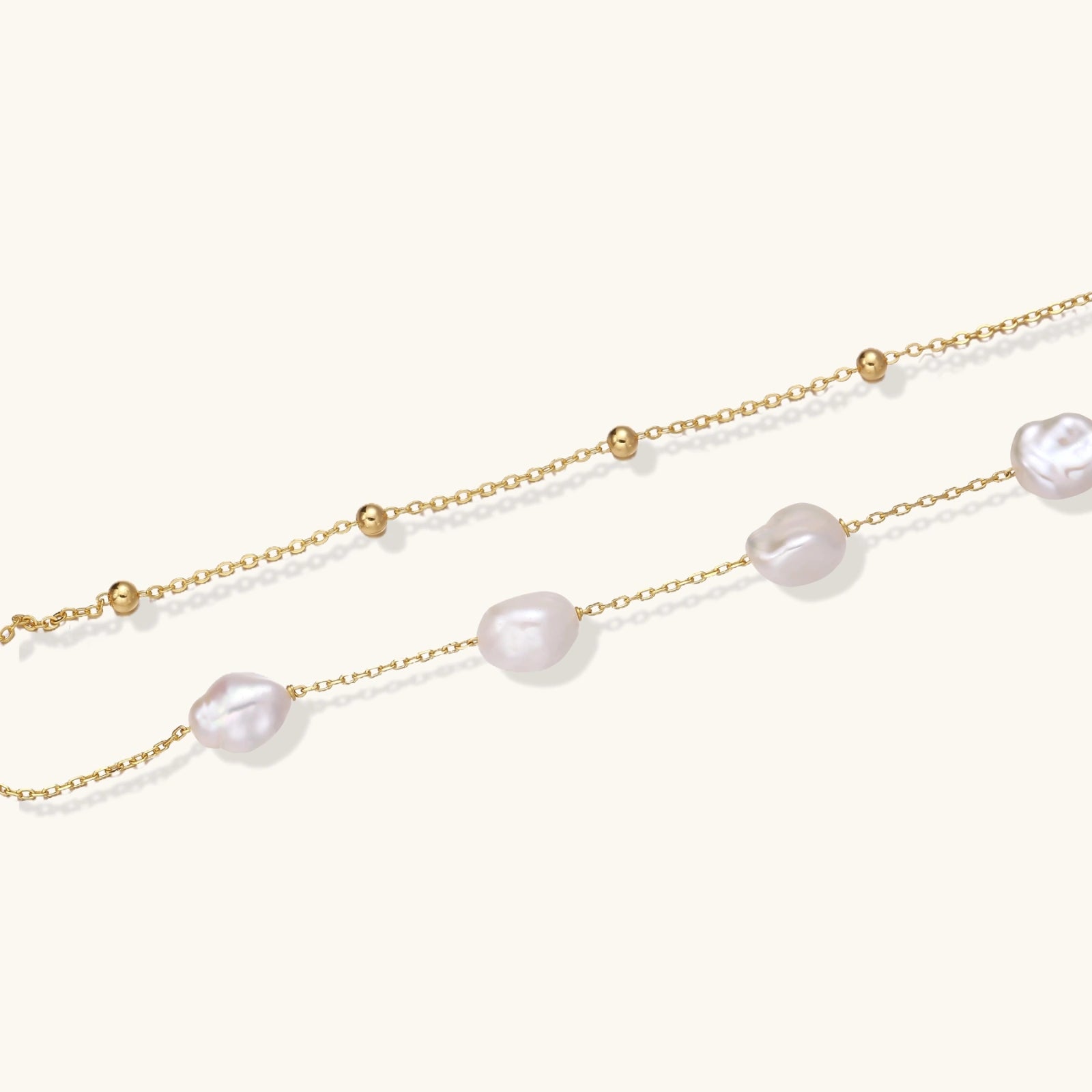 Flat lay of baroque pearl double chain vermeil bracelet with freshwater pearls