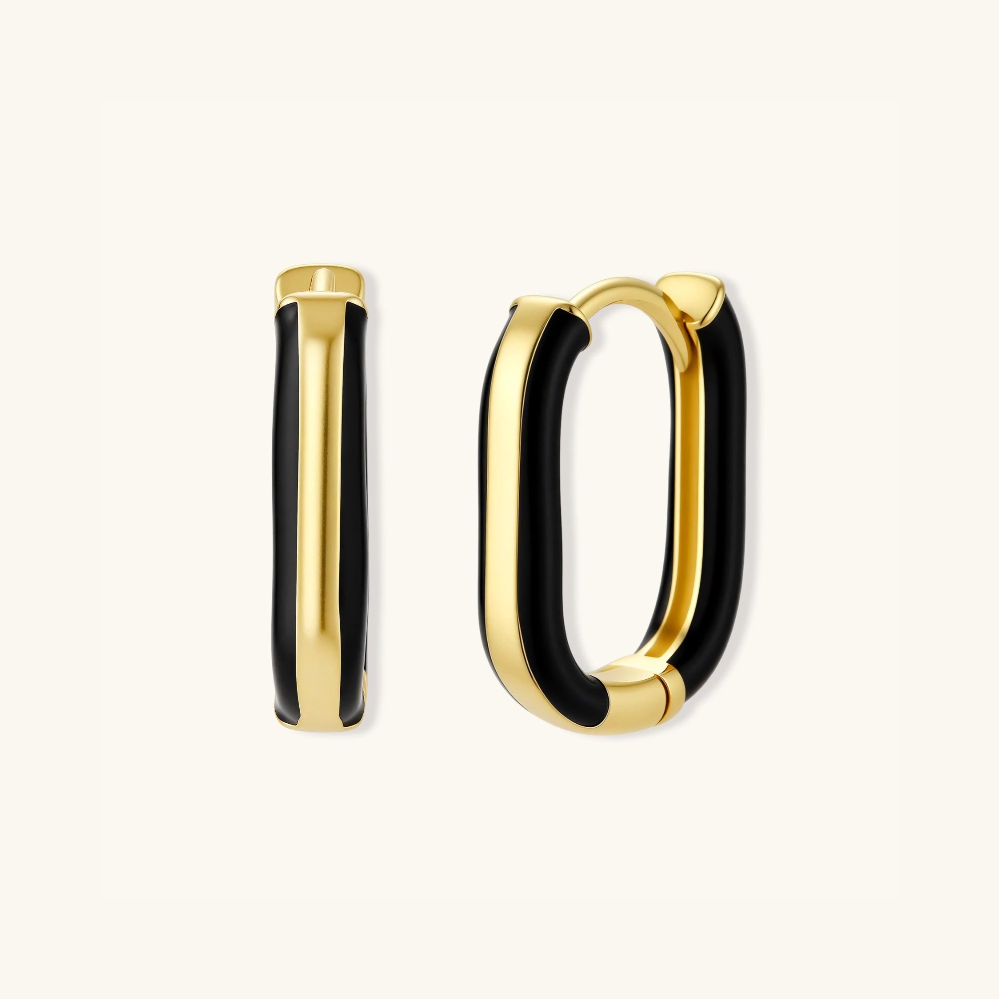 Overlapping pair of black enamel gold hoop earrings showing oval shape and enamel detail by VAHN Jewels