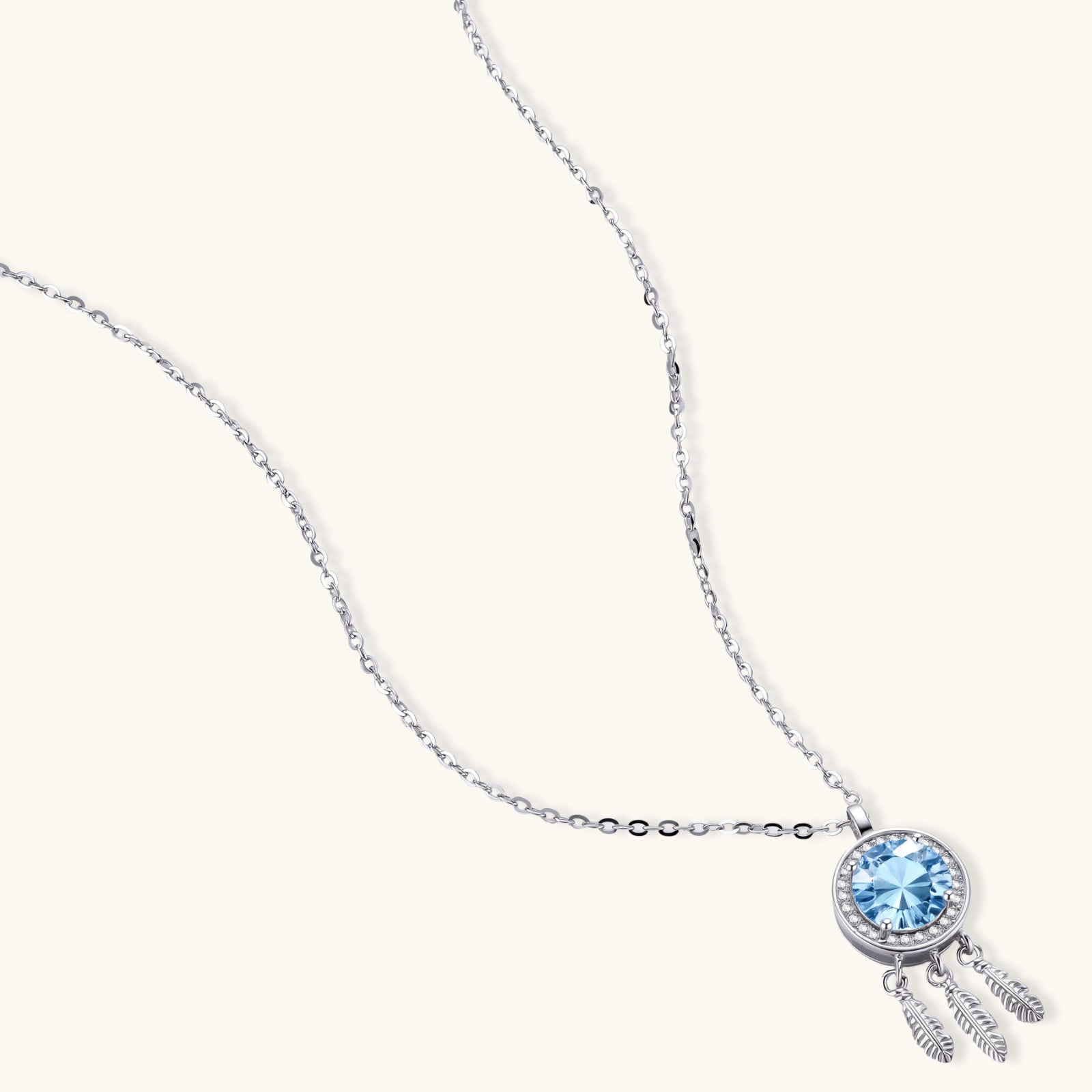 Full length view of blue moissanite feather pendant necklace on fine 925 silver cable chain by VAHN Jewels