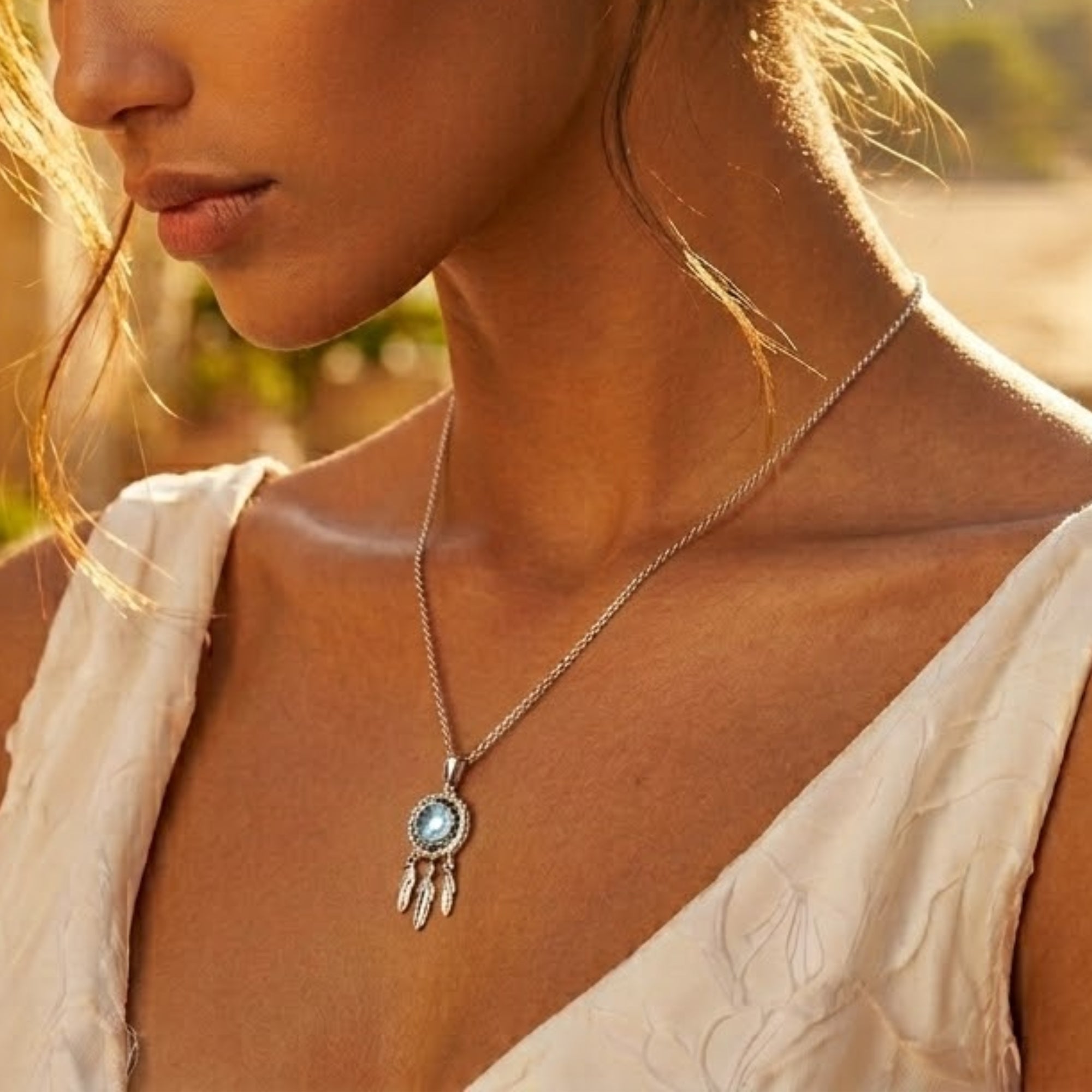 Editorial portrait of woman wearing blue moissanite feather pendant necklace by VAHN Jewels