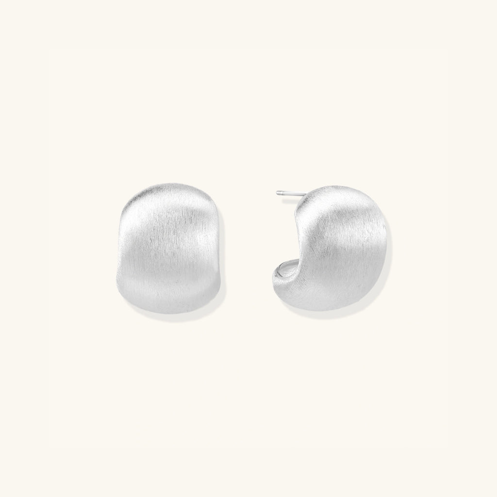 Close-up of brushed matte silver pebble studs in 925 sterling silver