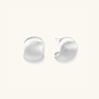 Close-up of brushed matte silver pebble studs in 925 sterling silver