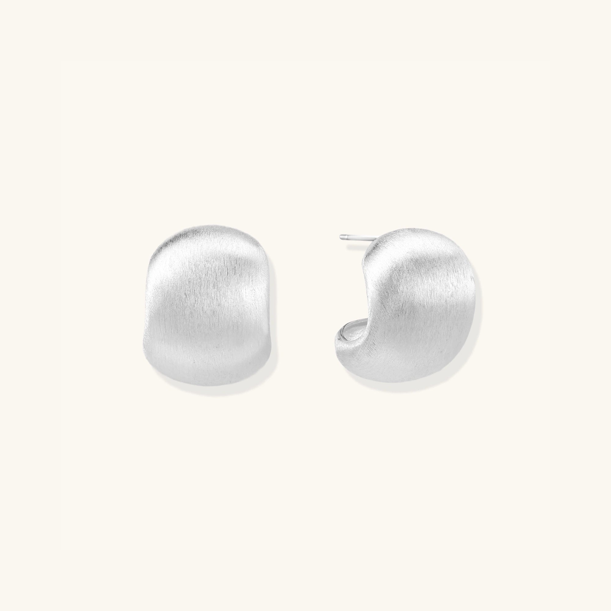 Close-up of brushed matte silver pebble studs in 925 sterling silver