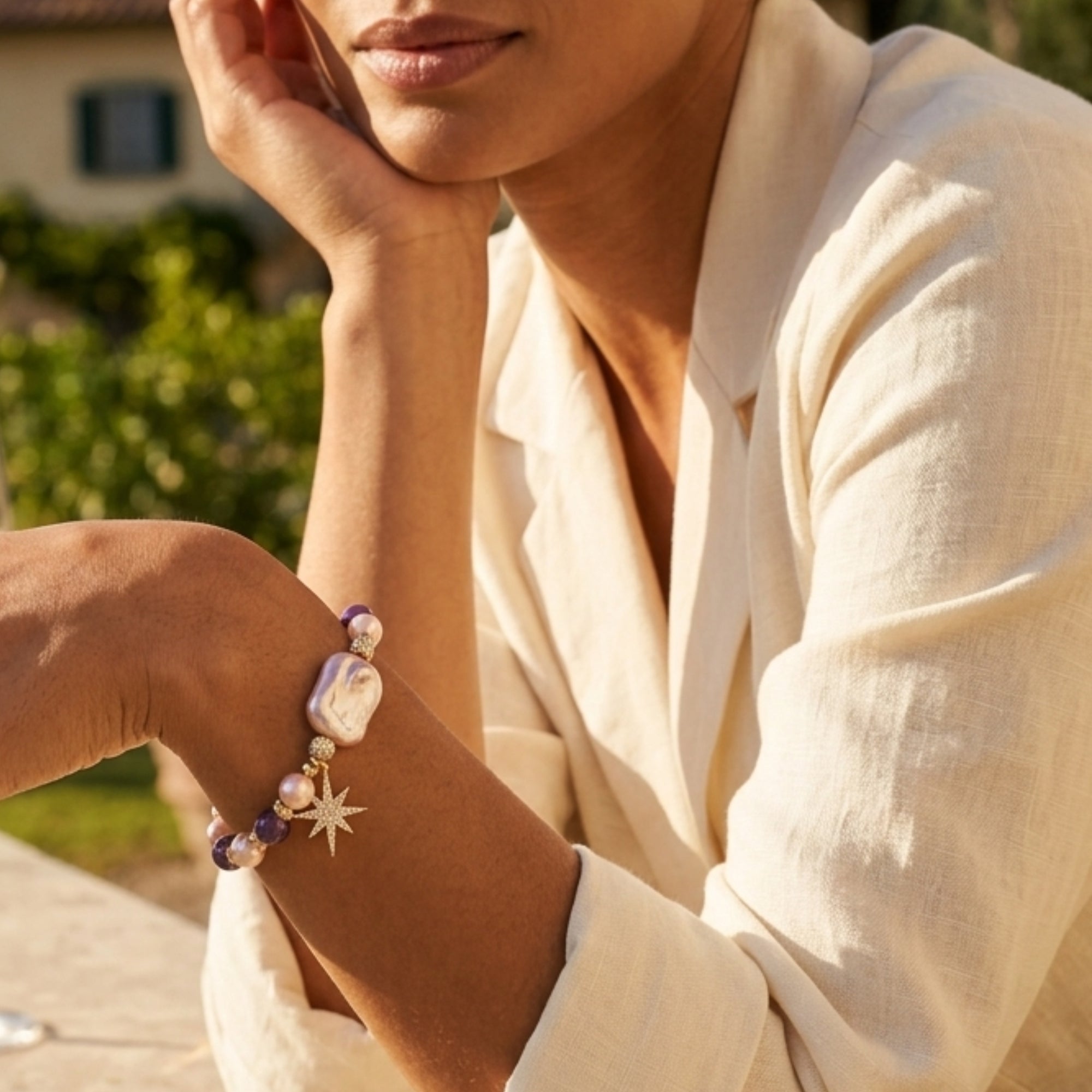 Woman wearing celestial amethyst pearl bracelet at golden hour by VAHN Jewels