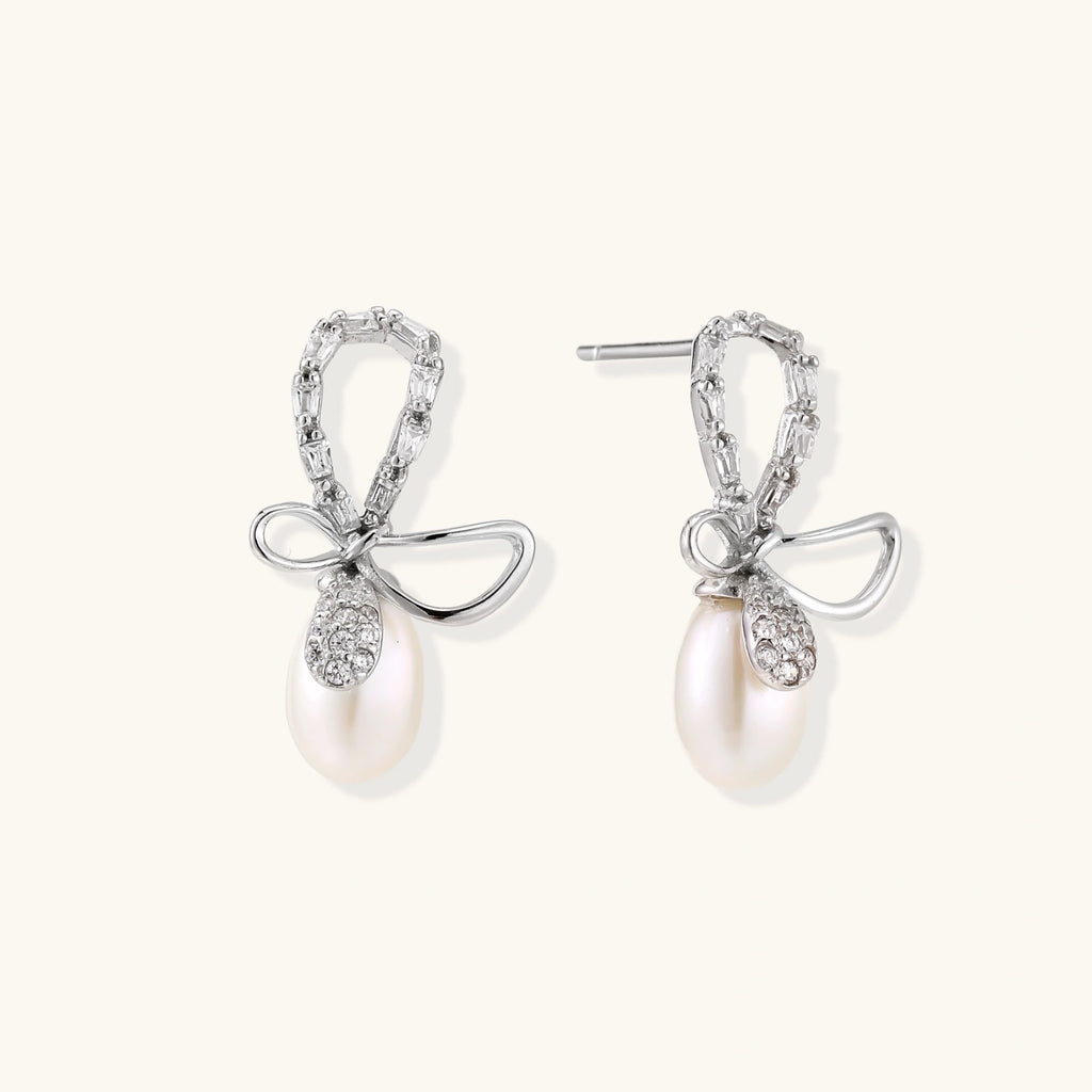 Close-up of crystal bow with freshwater pearl drop in rhodium-plated silver