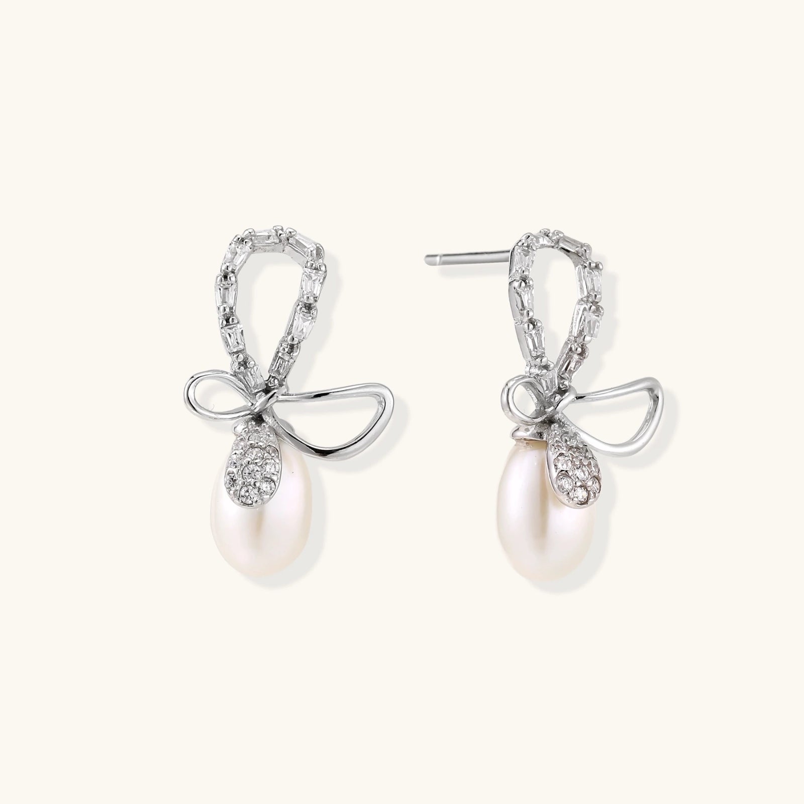 Close-up of crystal bow with freshwater pearl drop in rhodium-plated silver