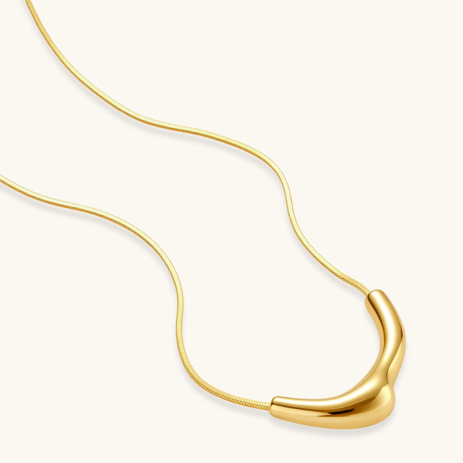 Full length view of 18K gold-plated 925 silver curve pendant necklace on fine snake chain by VAHN Jewels