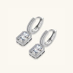 Pair view of emerald cut moissanite drop earrings showing pave huggie hoop and rectangular moissanite drop by VAHN Jewels