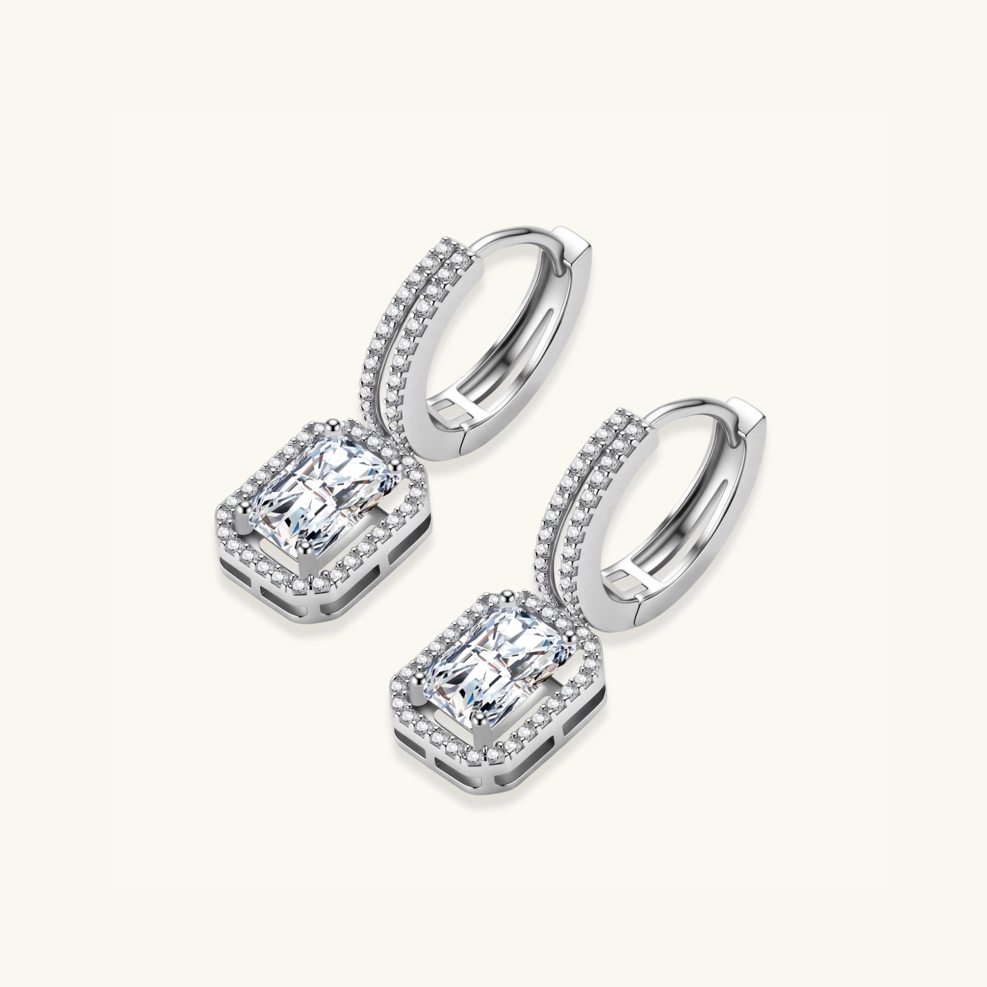 Pair view of emerald cut moissanite drop earrings showing pave huggie hoop and rectangular moissanite drop by VAHN Jewels