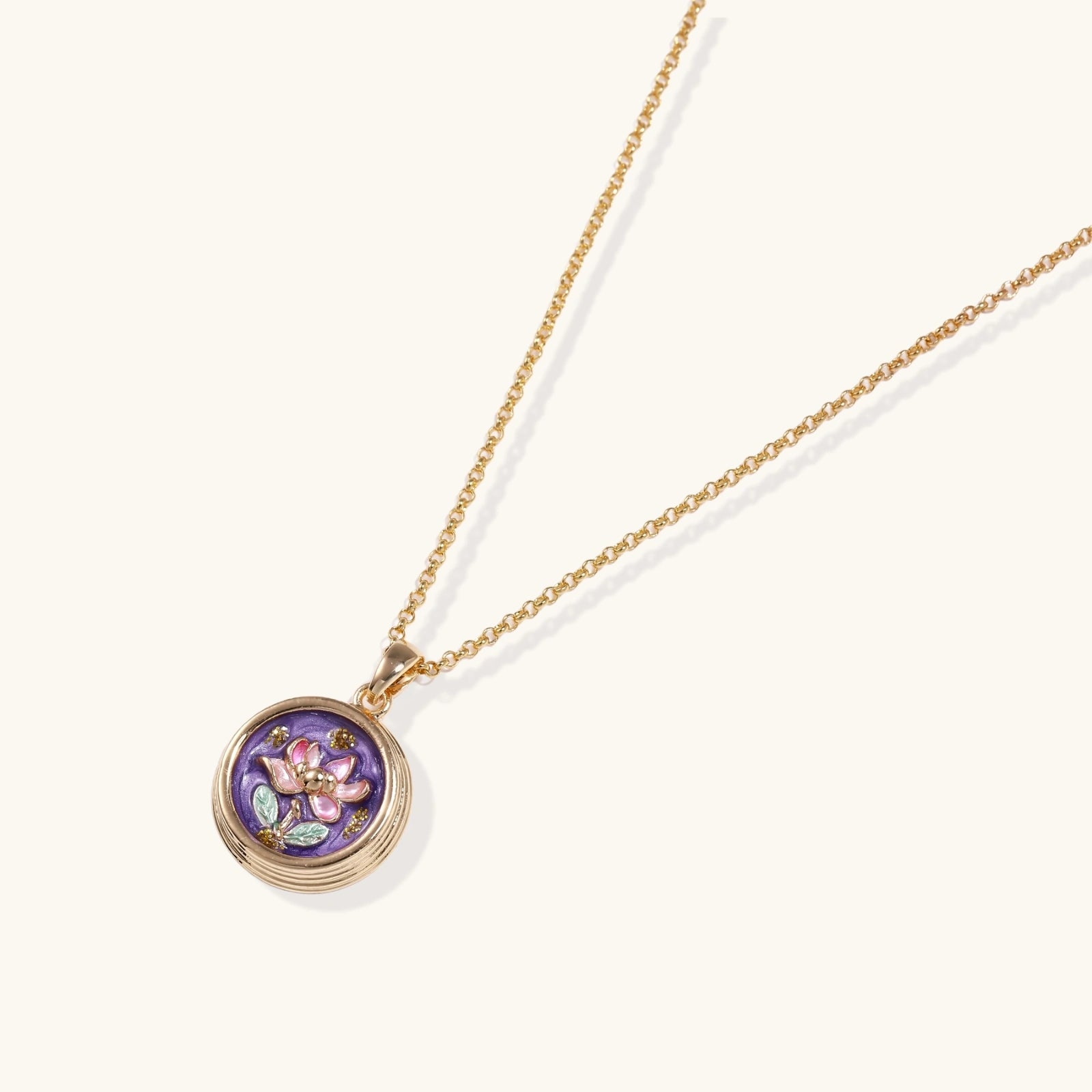 Close up of hand-painted flower enamel pendant in 18K gold plated eco brass VAHN Jewels