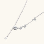 Close-up of pave butterfly charms and 1ct VVS1 moissanite drop on Flutter Dreams 925 sterling silver lariat necklace by VAHN Jewels