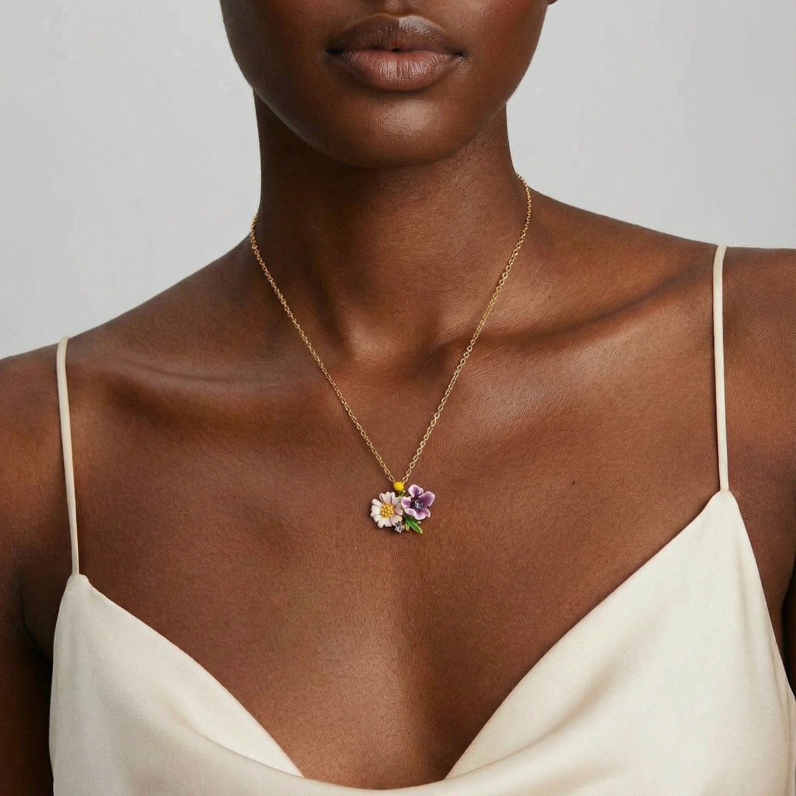 Woman wearing garden bouquet enamel necklace in 18K gold plated eco-brass by VAHN Jewels