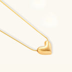 Close-up of brushed sculpted gold heart pendant in 18K gold-plated 925 sterling silver by VAHN Jewels