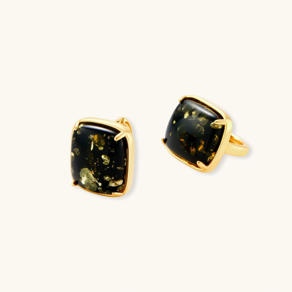 Angled view of green amber cabochon stud earrings showing prong setting and stone depth by VAHN Jewels