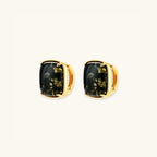 Pair view of green amber cabochon stud earrings showing golden inclusions in cushion-cut stones by VAHN Jewels