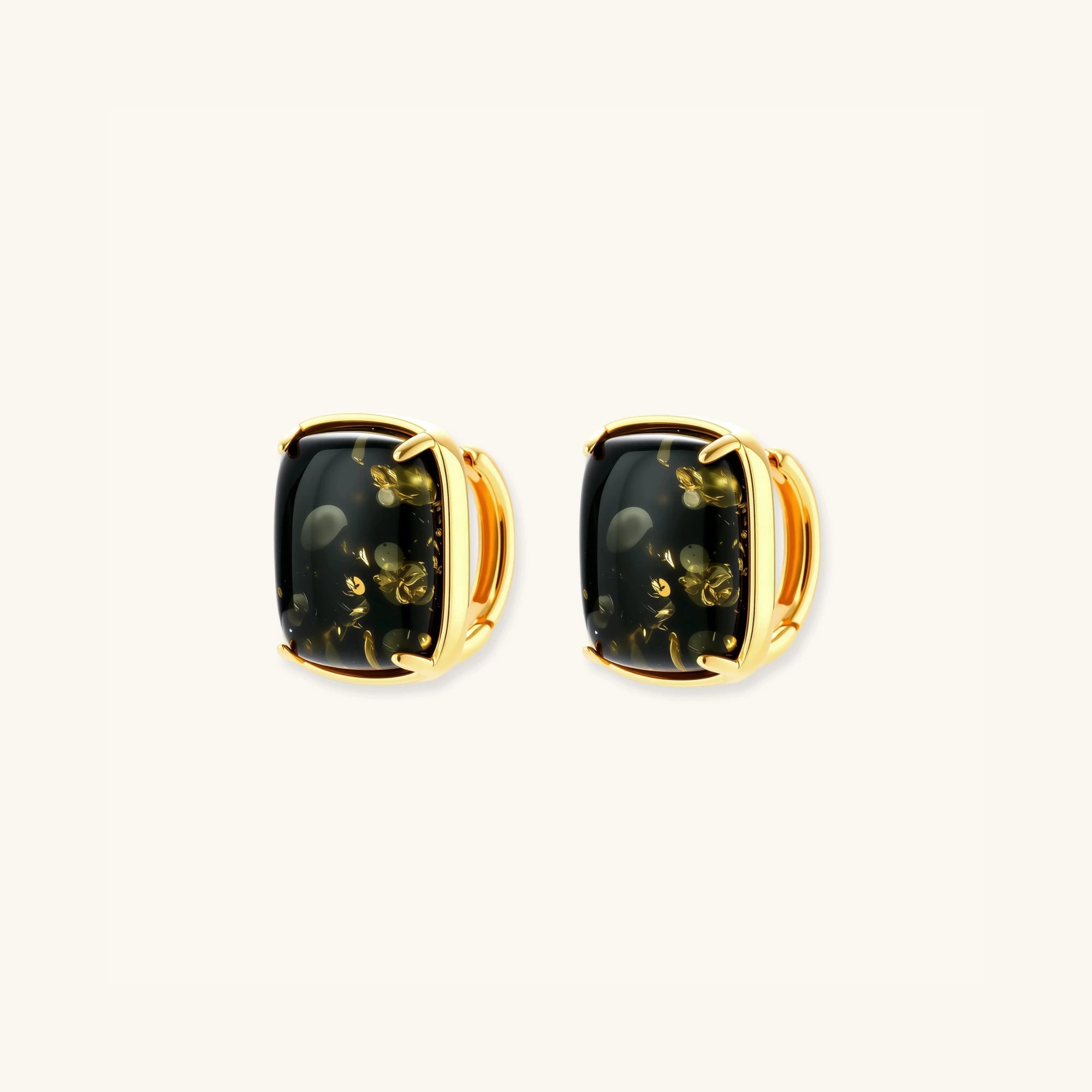Pair view of green amber cabochon stud earrings showing golden inclusions in cushion-cut stones by VAHN Jewels