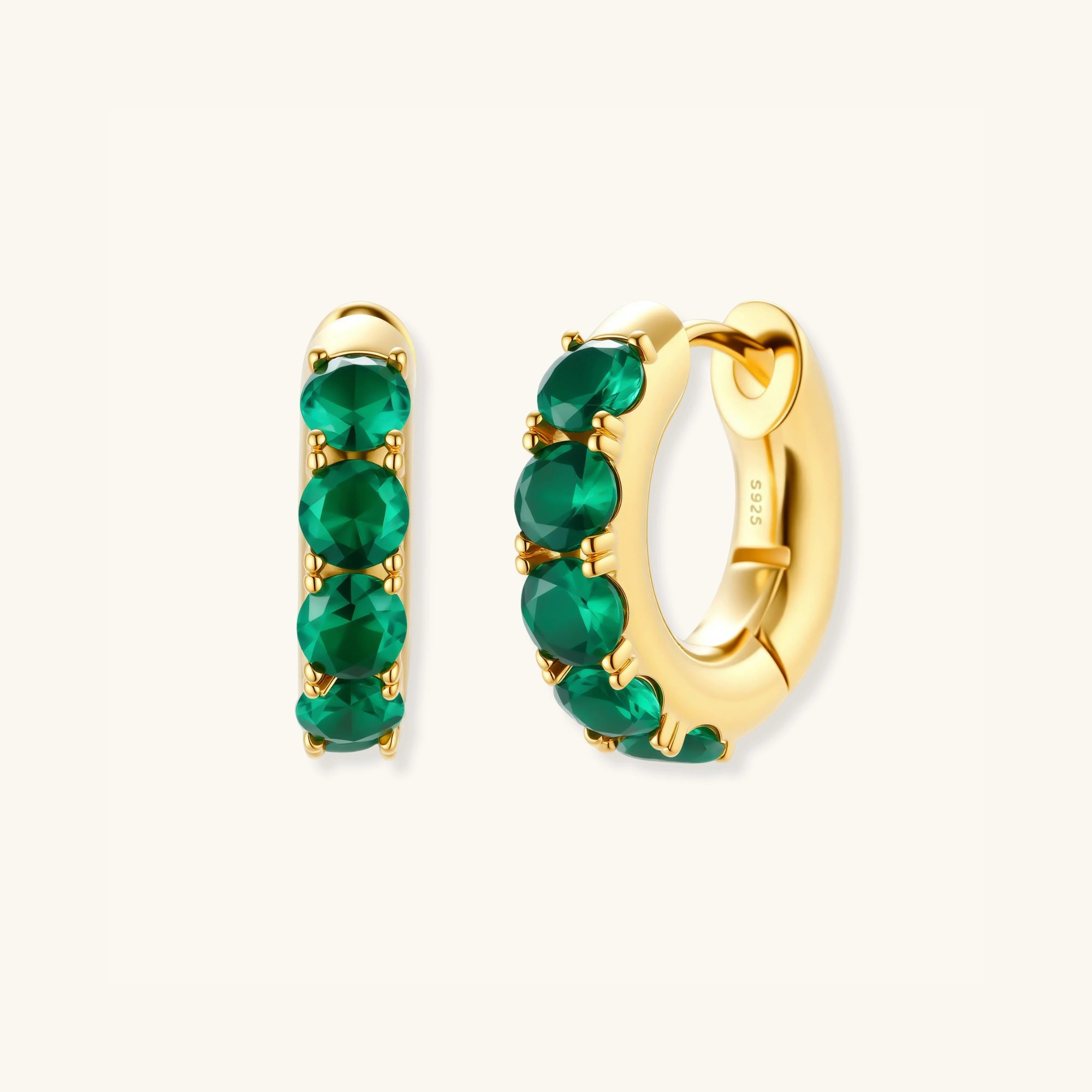 Standing view of green pave gold huggie hoop earrings showing emerald-green zirconia setting by VAHN Jewels