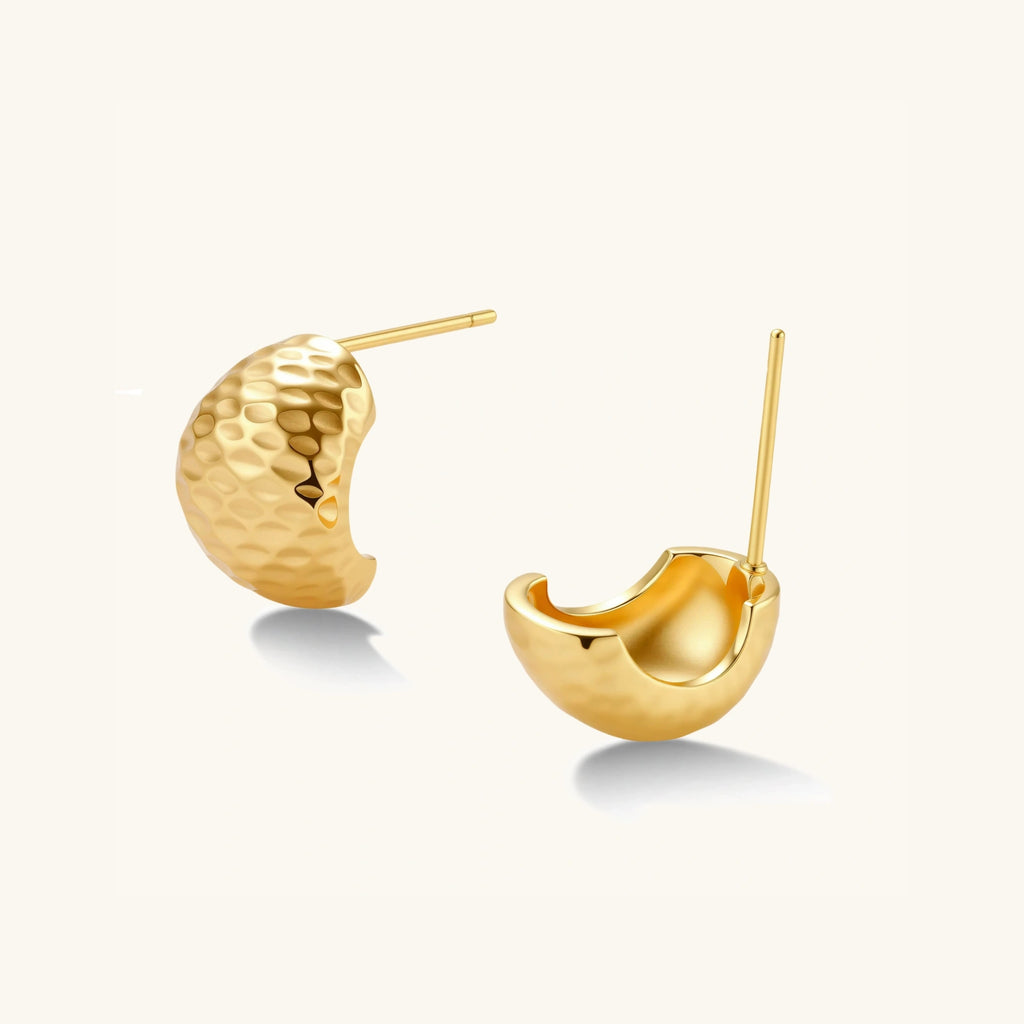 Angled view of hammered gold huggie earrings showing arc shape and post backing by VAHN Jewels