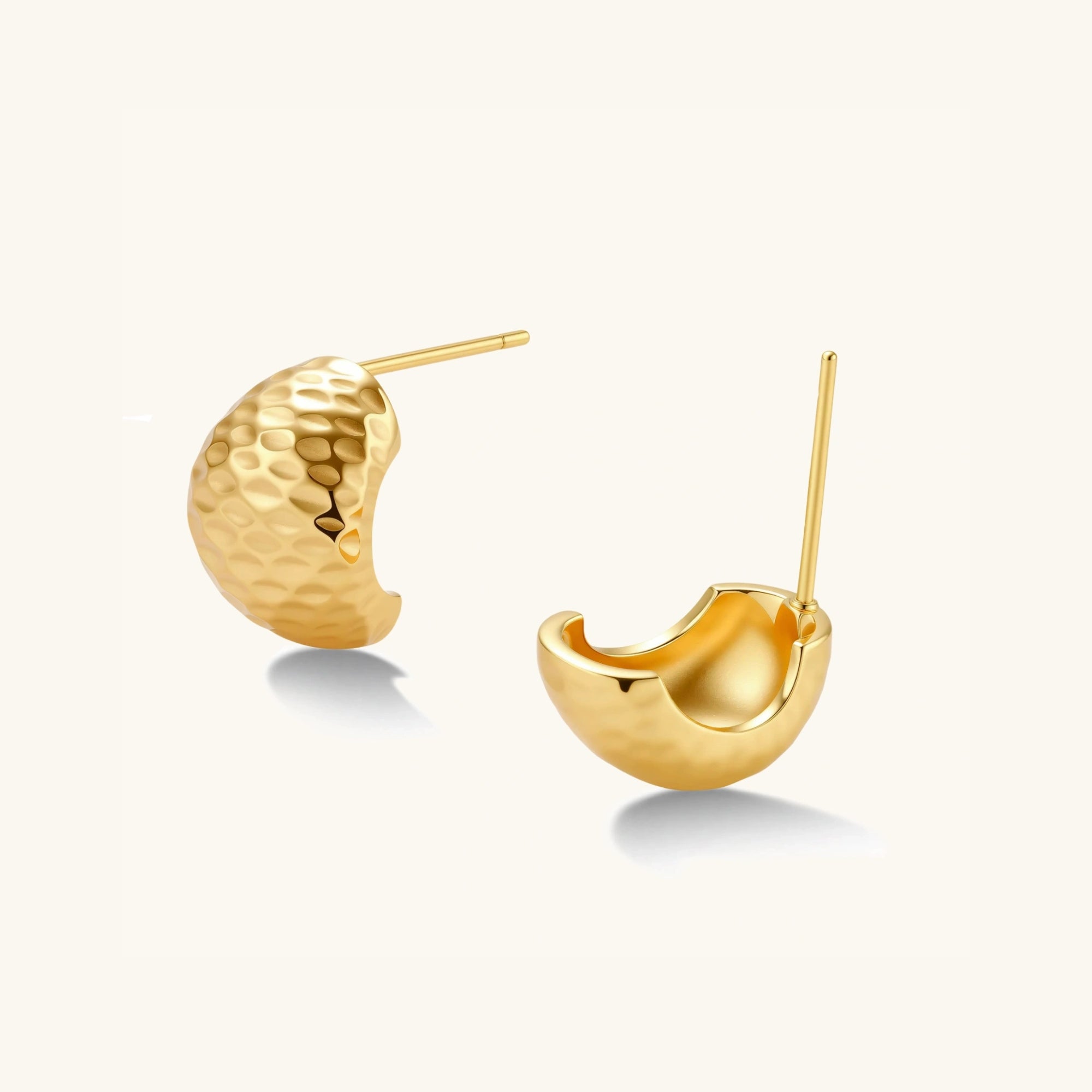 Angled view of hammered gold huggie earrings showing arc shape and post backing by VAHN Jewels