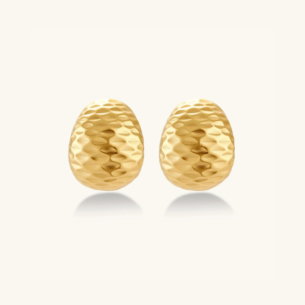 Hammered gold huggie earrings in 18K gold-plated 925 sterling silver with sculptural hammered texture by VAHN Jewels