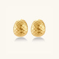 Hammered gold huggie earrings in 18K gold-plated 925 sterling silver with sculptural hammered texture by VAHN Jewels