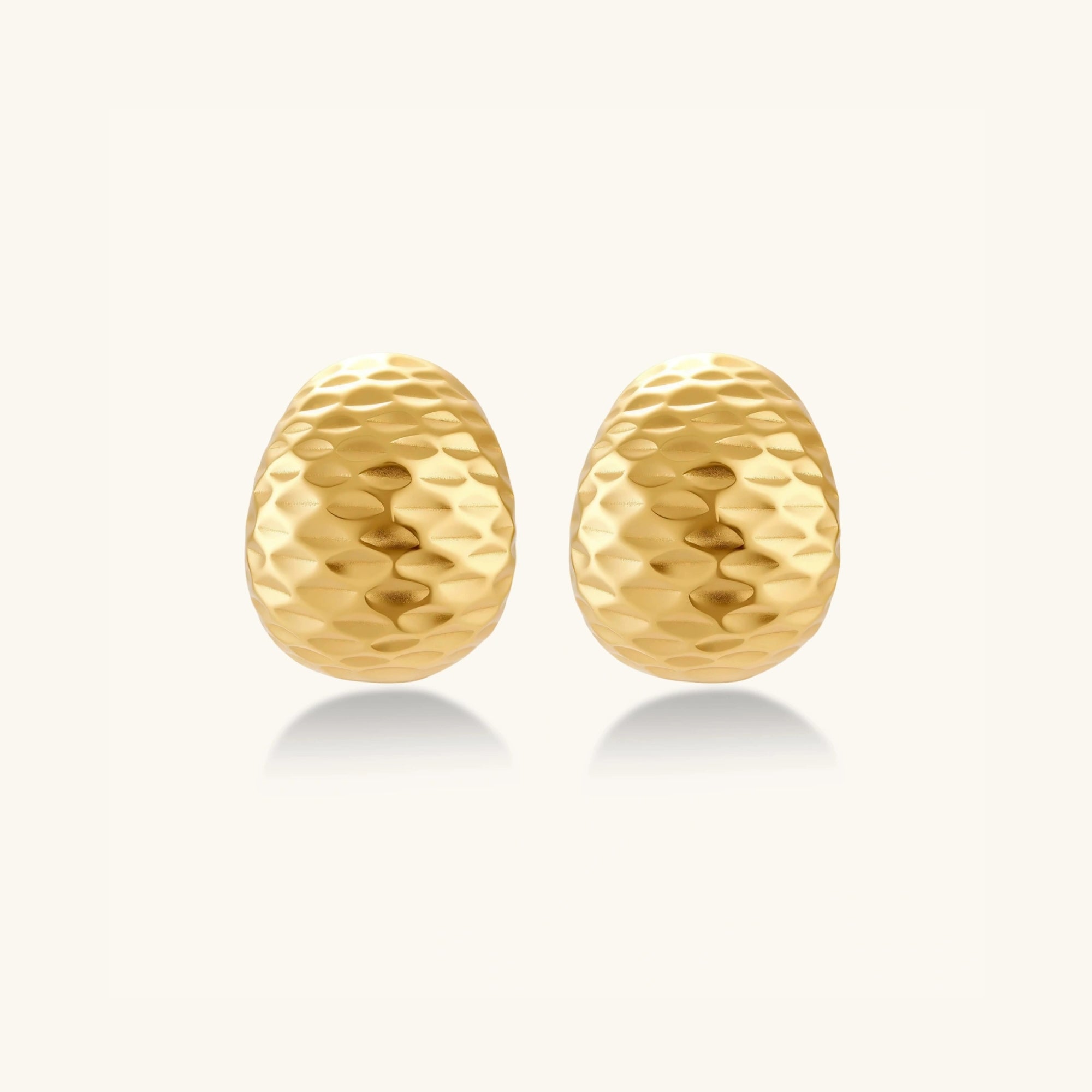 Hammered gold huggie earrings in 18K gold-plated 925 sterling silver with sculptural hammered texture by VAHN Jewels