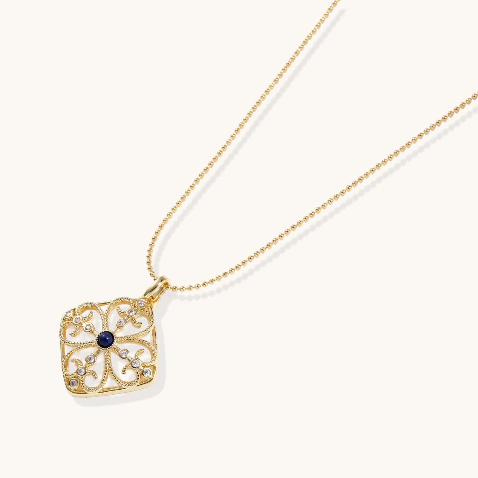 Close up of lapis lazuli filigree pendant with mother of pearl and 18K gold VAHN Jewels