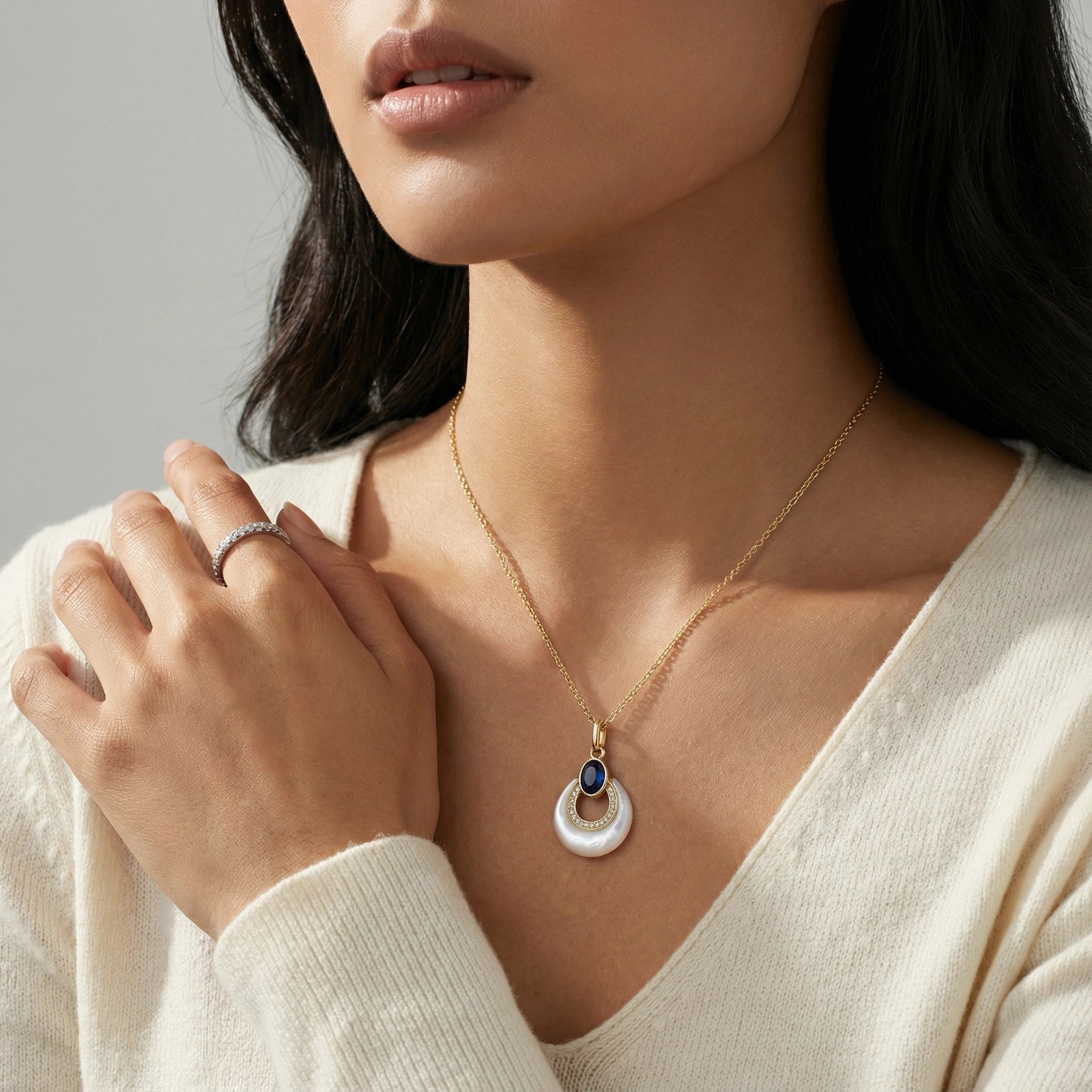Woman wearing lapis lazuli teardrop pendant necklace in 18K gold plated eco brass VAHN Jewels