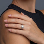 Woman wearing moissanite halo solitaire ring in silver | VAHN Jewels