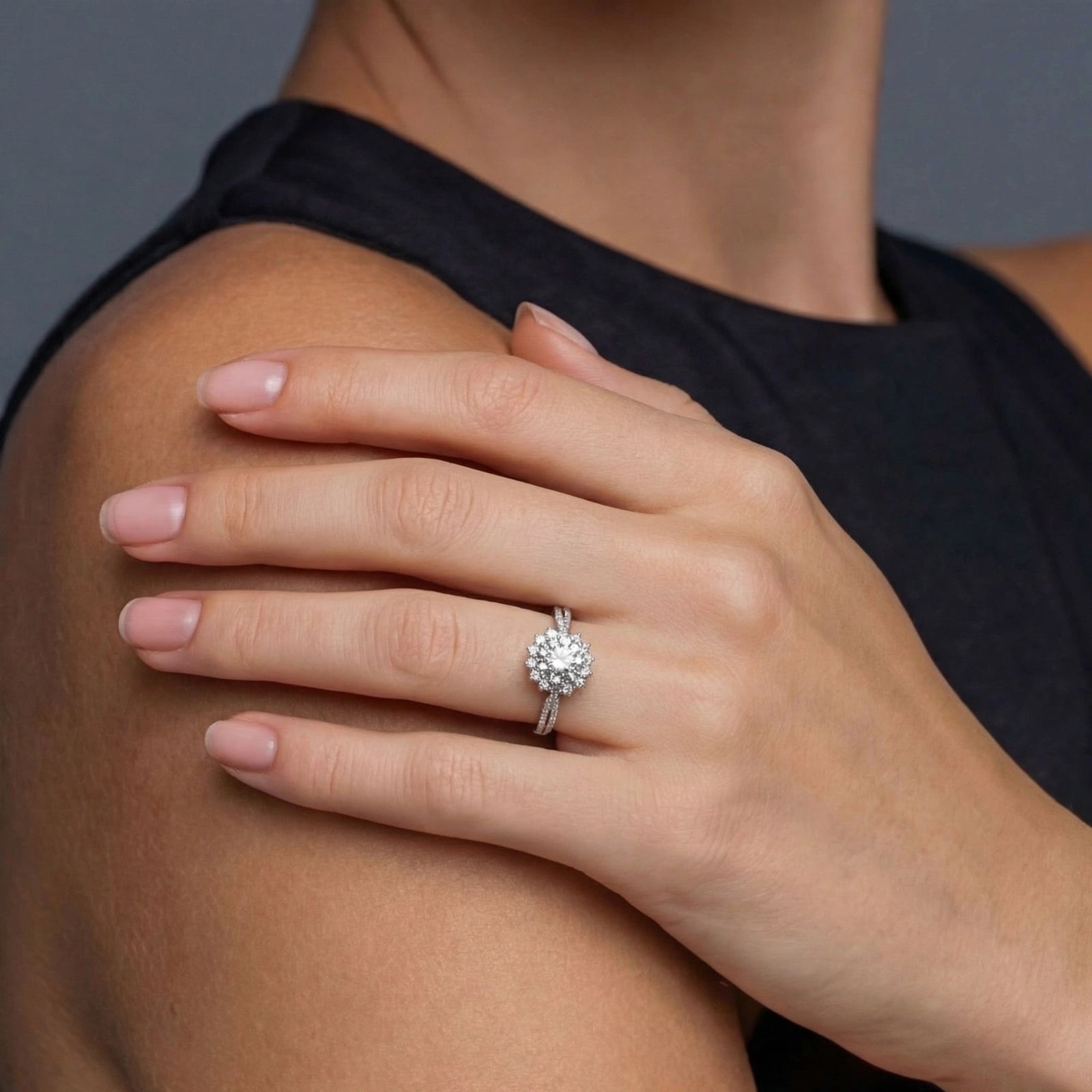 Woman wearing moissanite halo solitaire ring in silver | VAHN Jewels