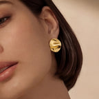 Woman wearing gold sculptural statement stud earrings | VAHN Jewels