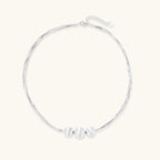 Flat lay of brushed silver multi-strand necklace with three silver beads in sterling silver 925