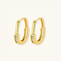 Pave gold huggie hoop earrings in 14K gold-plated 925 sterling silver with cubic zirconia along the arc by VAHN Jewels