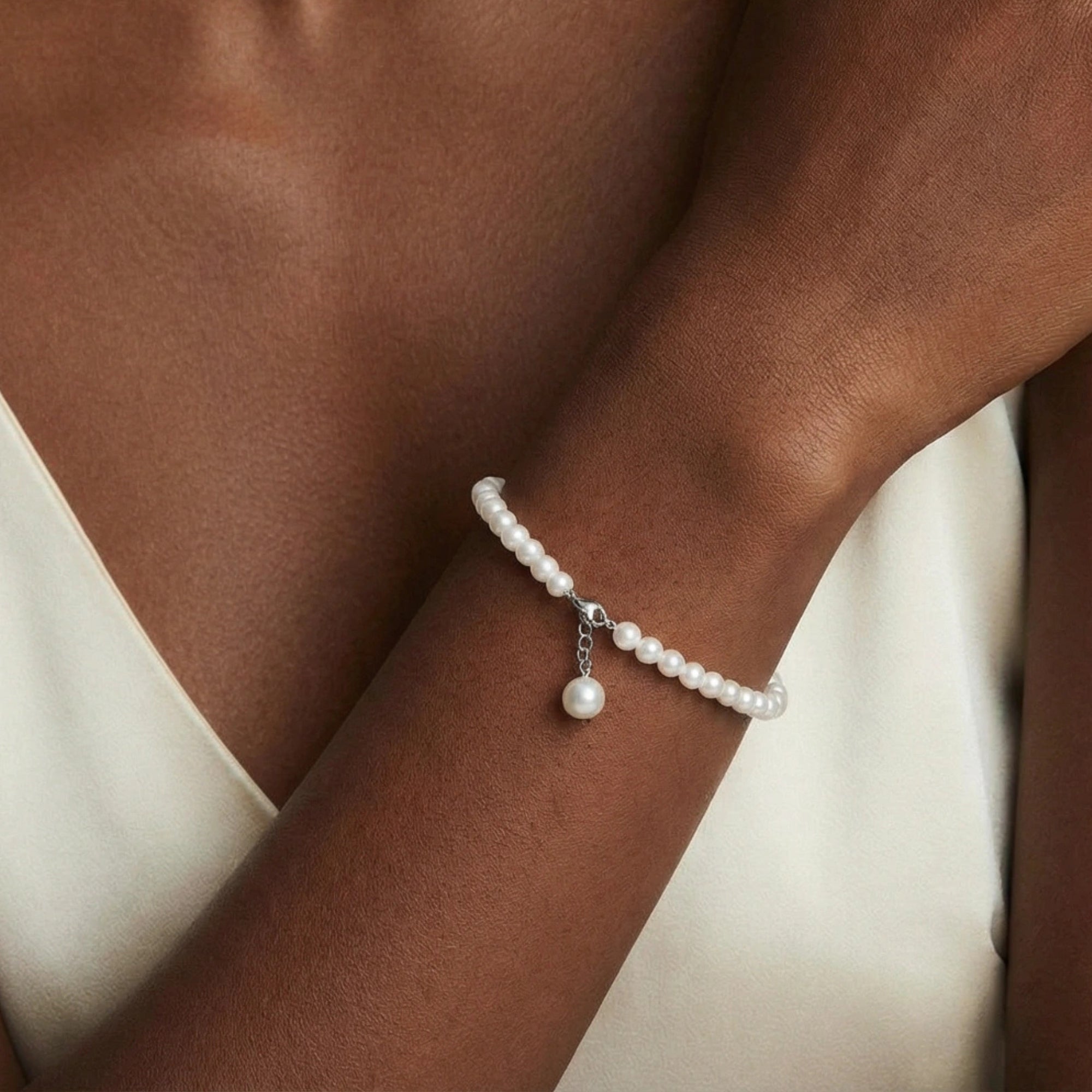 Woman wearing pearl beaded charm bracelet in silver | VAHN Jewels