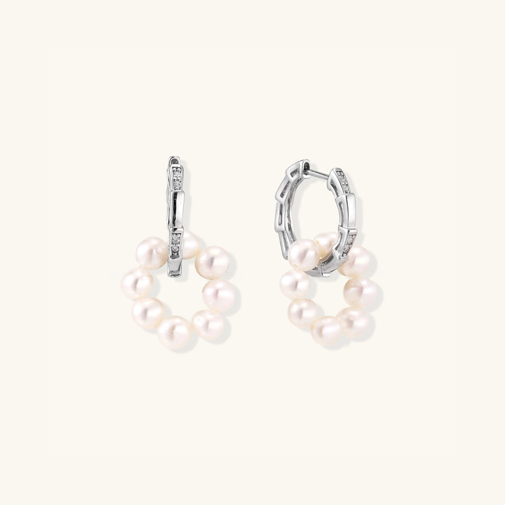 Close-up of pearl cluster huggie hoops in rhodium-plated silver