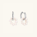Close-up of pearl cluster huggie hoops in rhodium-plated silver