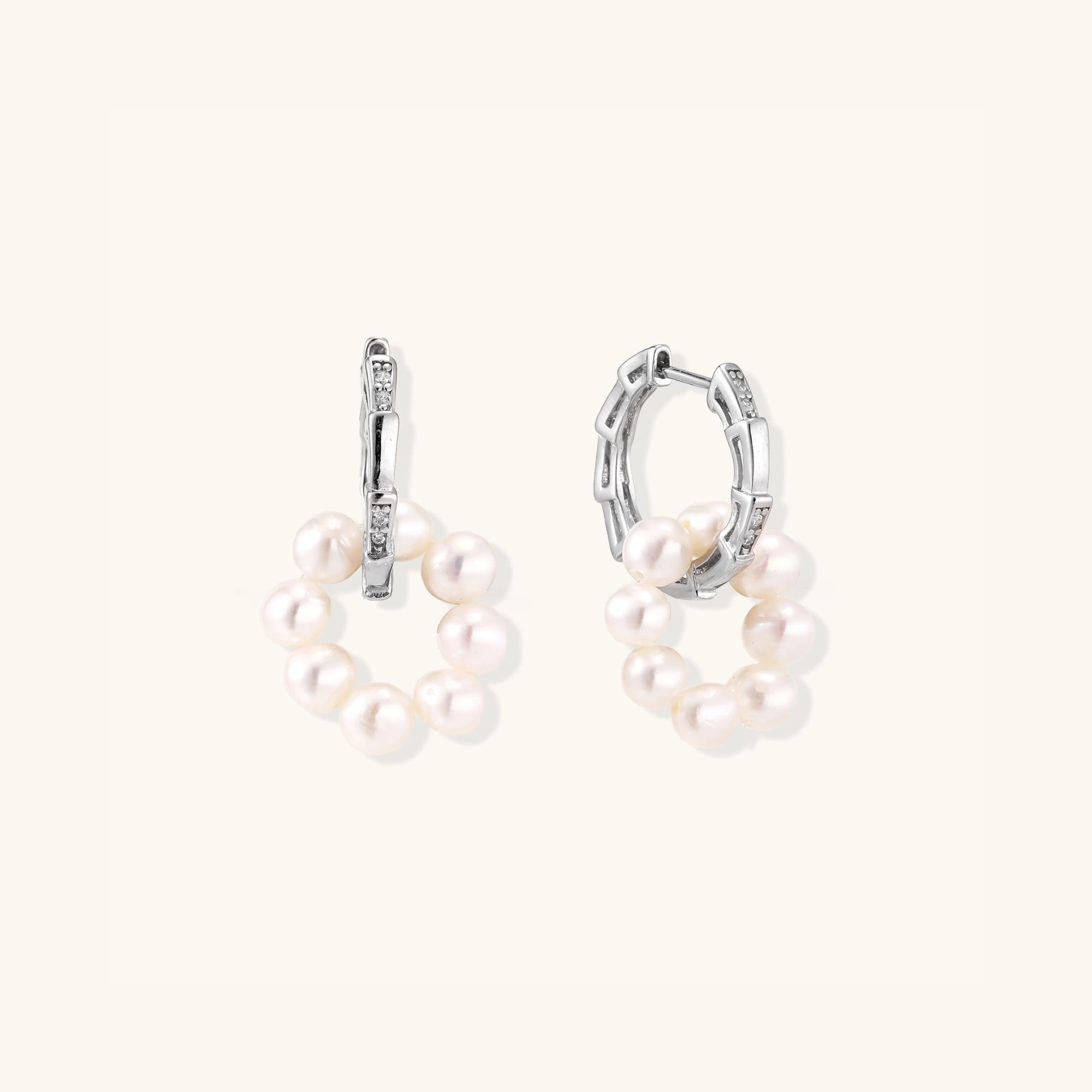 Close-up of pearl cluster huggie hoops in rhodium-plated silver